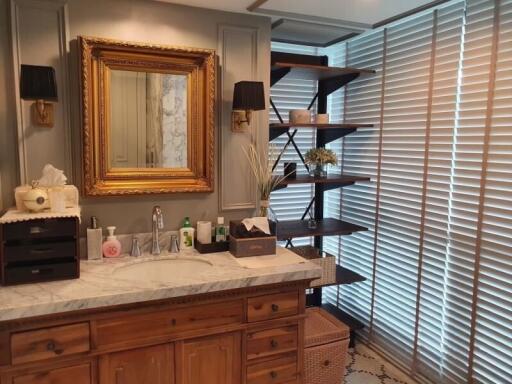 Elegant bathroom with marble countertop and shelves