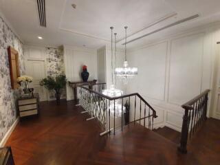 Elegant hallway with chandeliers and wooden flooring