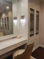 Elegant bedroom vanity area with built-in closets