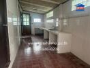 Kitchen with tiled walls, countertops, and sink