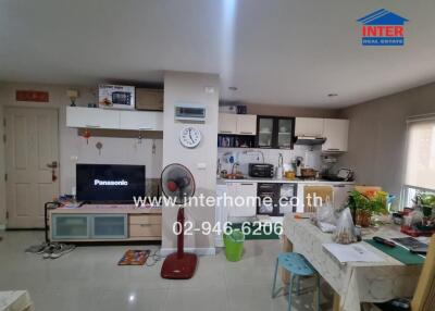 Kitchen and living area with appliances and dining table