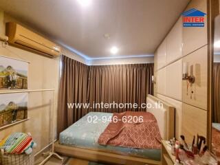 Bedroom with bed, curtains, and air conditioning unit