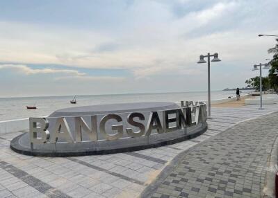 Beachfront promenade with Bangsaen sign and ocean view