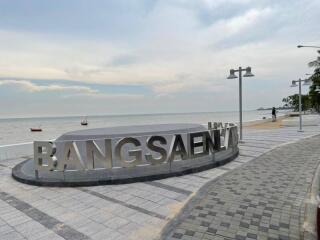 Beachfront promenade with Bangsaen sign and ocean view