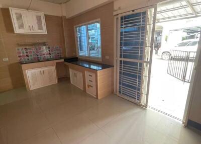 Modern kitchen with open door leading outside