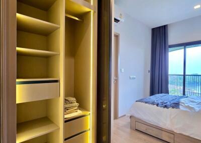Open closet and bedroom with a large window