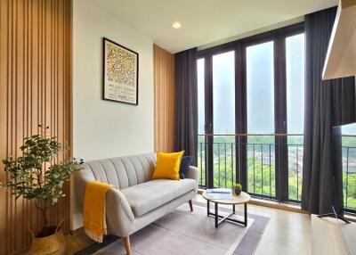 Well-lit living room with a large window and modern decor