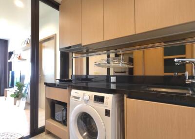 Modern kitchen with built-in washer and ample storage