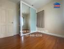 Bedroom with hardwood floors and a sliding-door closet