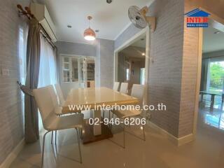 Modern dining room with white chairs and a wooden table