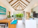 Modern open-plan kitchen and dining area with vaulted ceiling