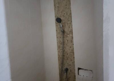 shower area with tiled wall