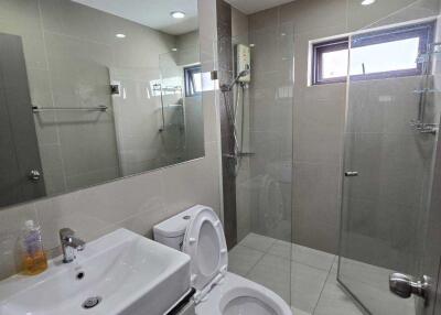 Modern bathroom with glass shower and white fixtures