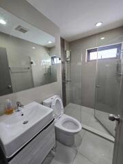 Modern bathroom with glass shower and white fixtures