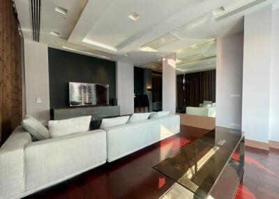 Spacious and modern living room with large sectional sofa and wall-mounted TV