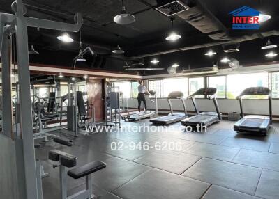 Well-equipped gym with various exercise machines, treadmills, and large mirrors.