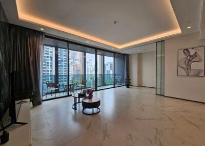 Spacious living room with large windows and city view