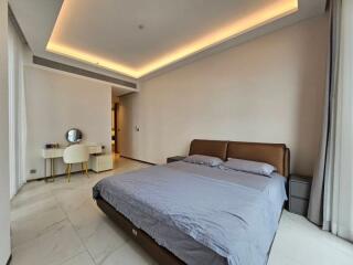 Modern bedroom with a bed, nightstands, and a vanity desk