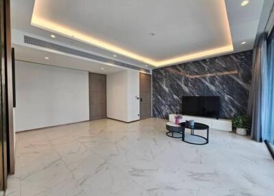 Modern living room with marble accent wall and TV