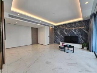 Modern living room with marble accent wall and TV