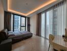 Modern bedroom with large windows, bed, and desk