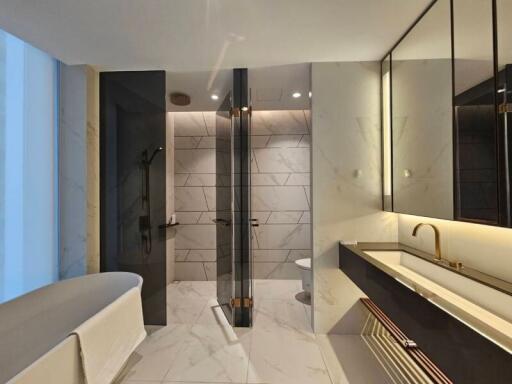 Modern bathroom with bathtub, shower, and double sink