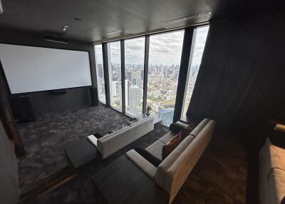 Modern high-rise living room with floor-to-ceiling windows and city view