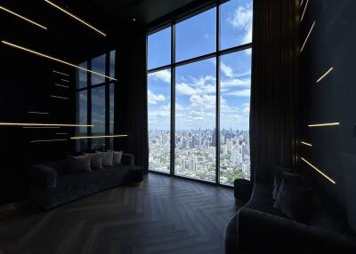 Living room with large floor-to-ceiling windows offering city view