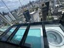 Rooftop balcony view with pool and cityscape