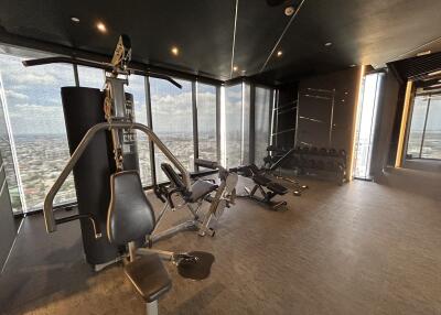 Modern gym with fitness equipment and city view