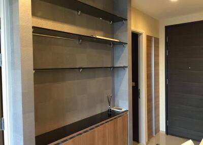 Modern entryway with built-in shelves and wooden cabinetry