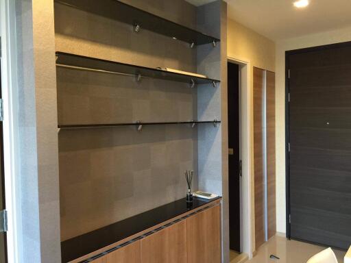 Modern entryway with built-in shelves and wooden cabinetry