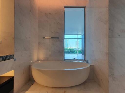 Modern bathroom with large bathtub and city view