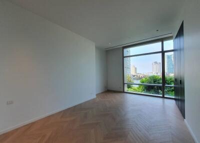 Spacious living room with large window and city view