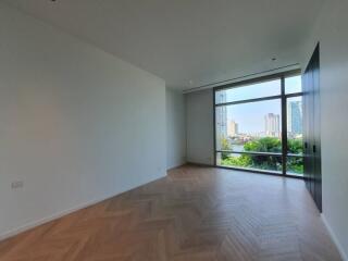 Spacious living room with large window and city view