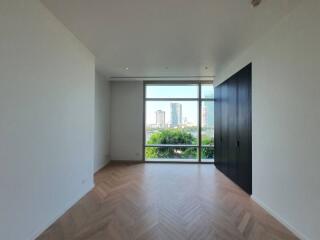 Spacious bedroom with large window and city view