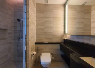 Modern bathroom with glass shower and wall-mounted toilet