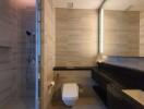 Modern bathroom with glass shower and wall-mounted toilet