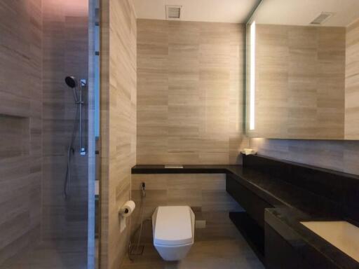 Modern bathroom with glass shower and wall-mounted toilet