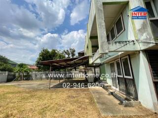 Exterior view of a residential building with a yard