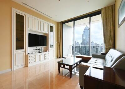 Spacious living room with large windows, city view, and modern furniture