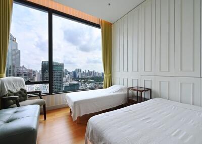 Modern bedroom with two beds and city view