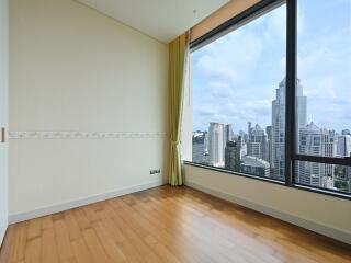 Bedroom with large window offering city view.