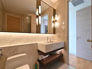 Modern bathroom with a large mirror and stylish lighting