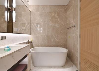 Modern bathroom with tub and marble walls