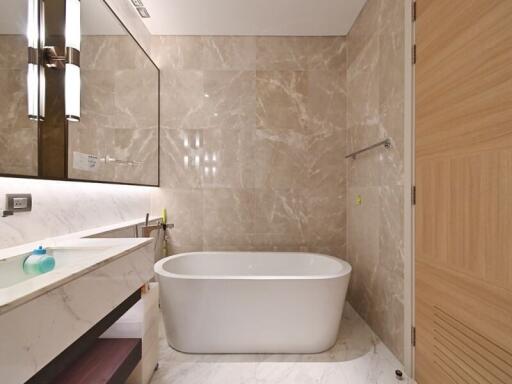 Modern bathroom with tub and marble walls