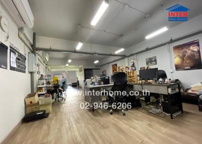 Spacious office area with workstations and storage