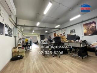 Spacious office area with workstations and storage