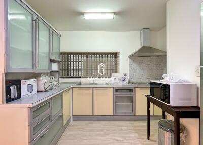 Spacious and modern kitchen with appliances and ample storage space