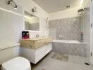 Modern bathroom with a vanity, bathtub, and toilet